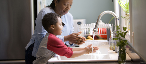 woman and boy washing hands