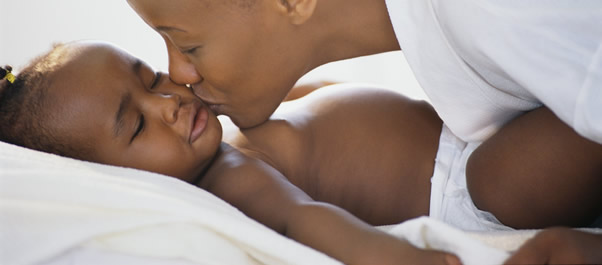 mom kissing baby