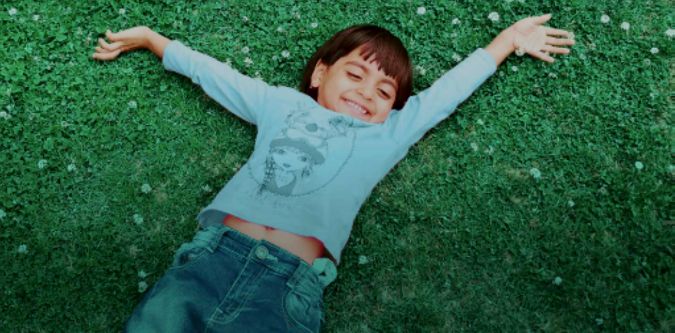 Boy laying in grass
