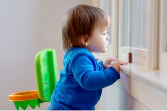 child looking out window