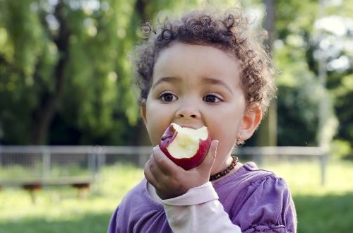 child eating an apple