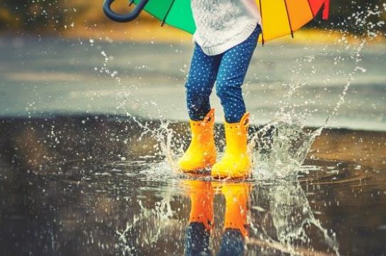 child in water puddle