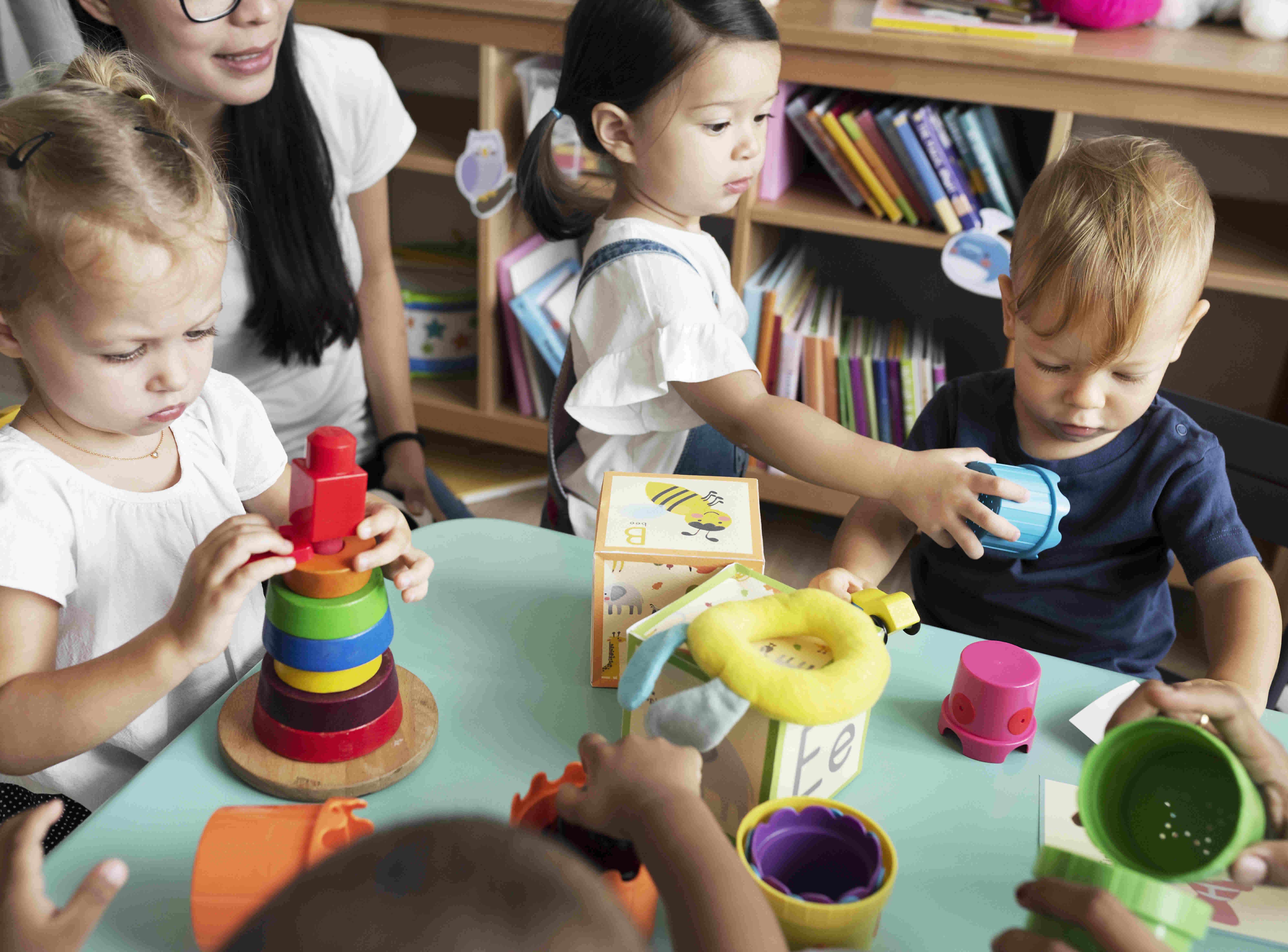 picture of children and a childcare provider playing