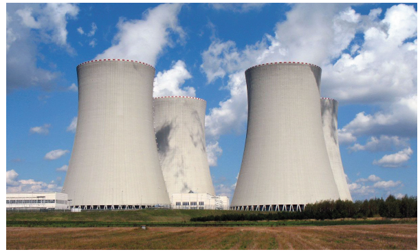 Photo of nuclear power plants with a blue cloudy sky in the background
