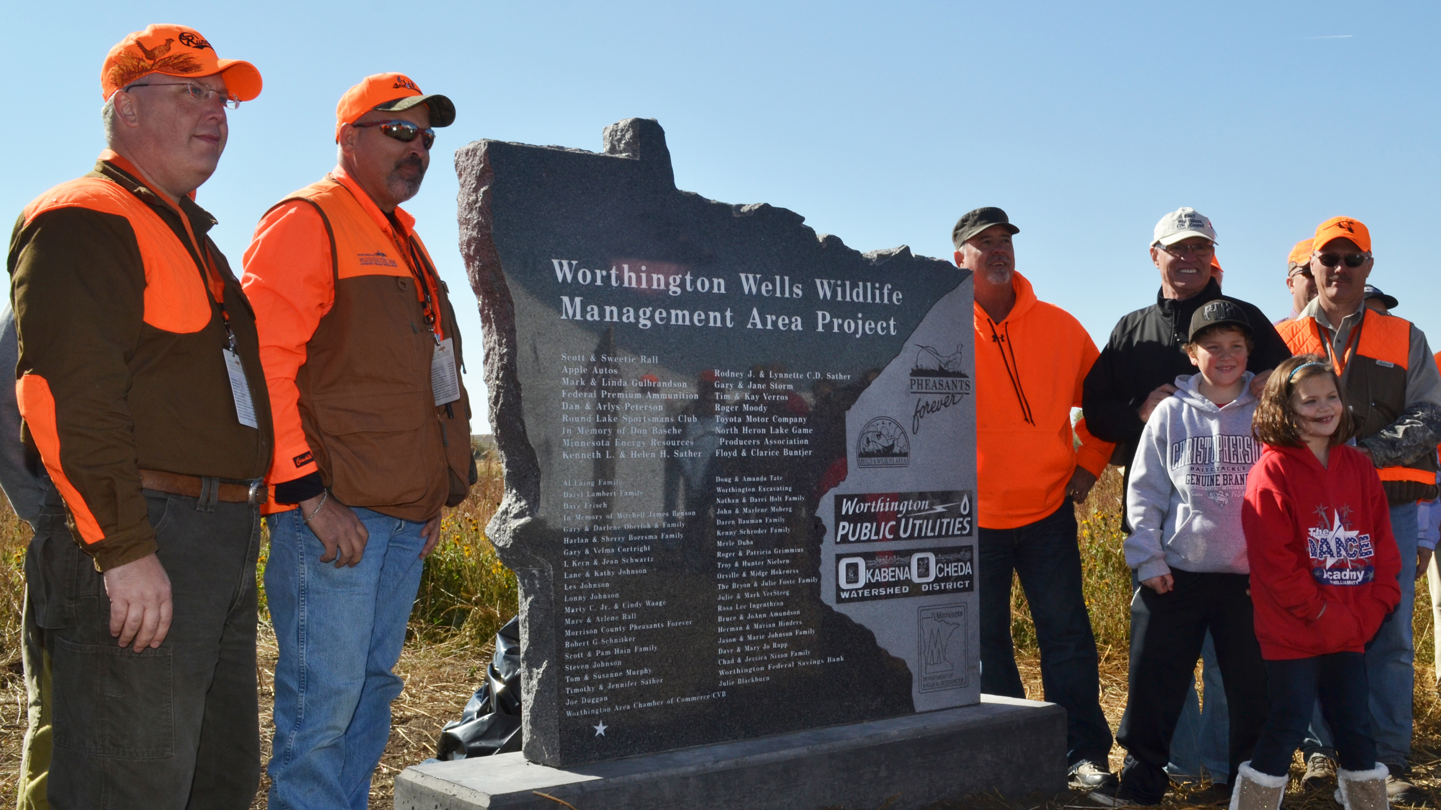  Group of people standing by the Worthington Wells Wildlife Management Area Project sign outdoors 