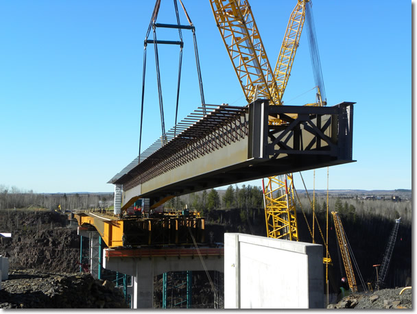 Girder being lifted into place on Highway 53 bridge