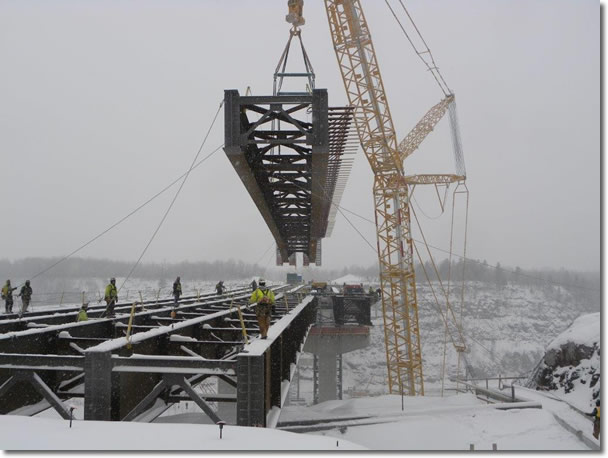 Girder being lifted into place on Highway 53 bridge