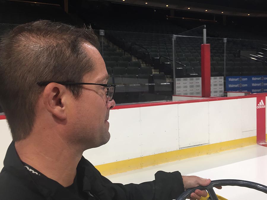 Chris Aase applying water to Wild rink