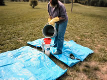 Person pouring bleach solution through funnel into well casing.