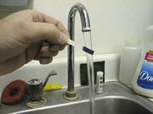 Test Paper being rinsed with tap water.