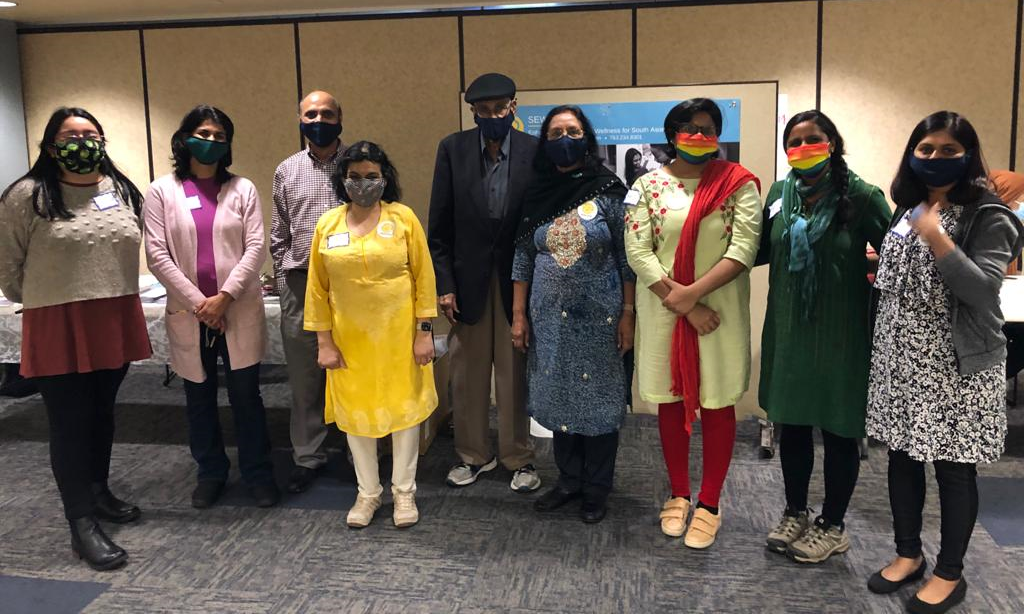 A group of people in Indian clothes wearing masks