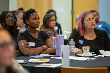 councilmembers and staff listen to event presenter