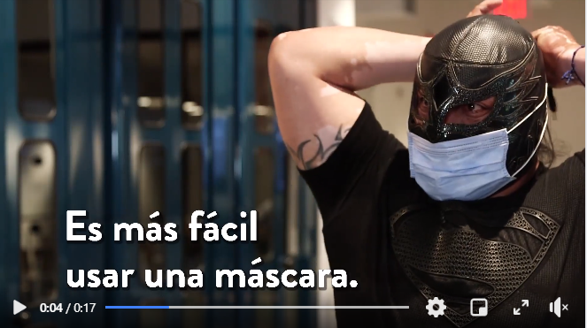 #MaskUpMN message with wrestler in Spanish