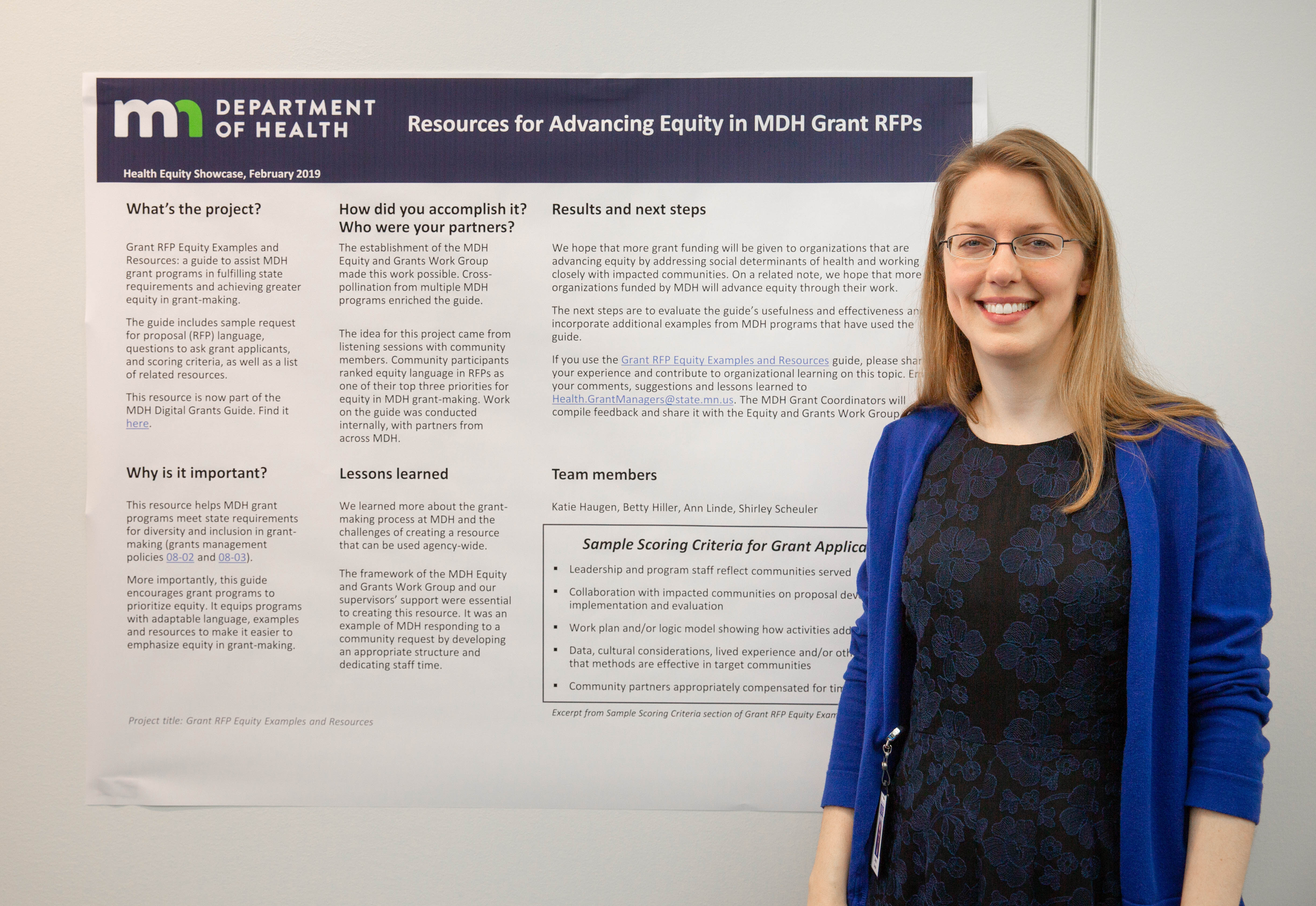 Photo of project lead with poster - grants guide project