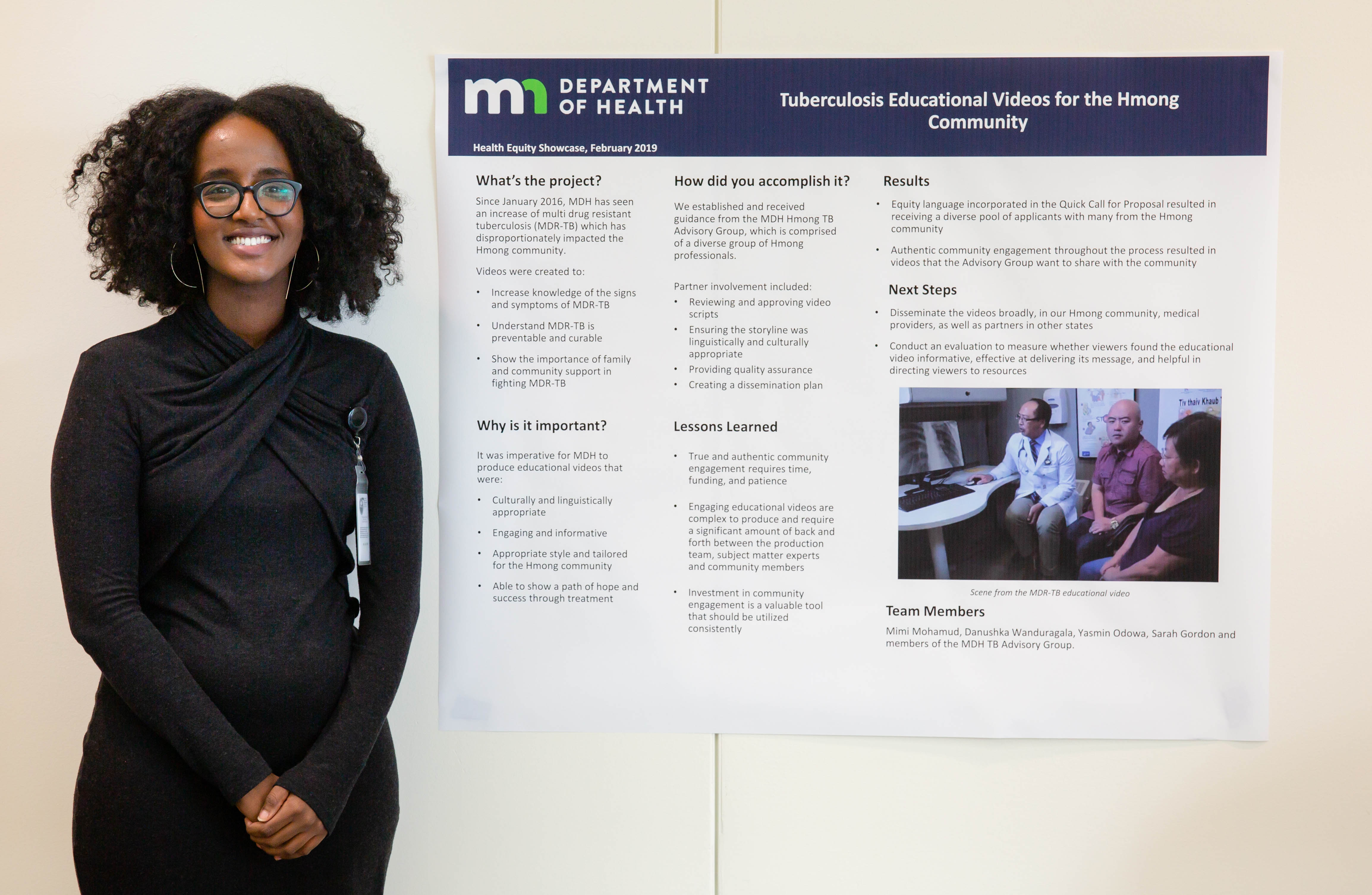 Photo of project lead with poster - tuberculosis project