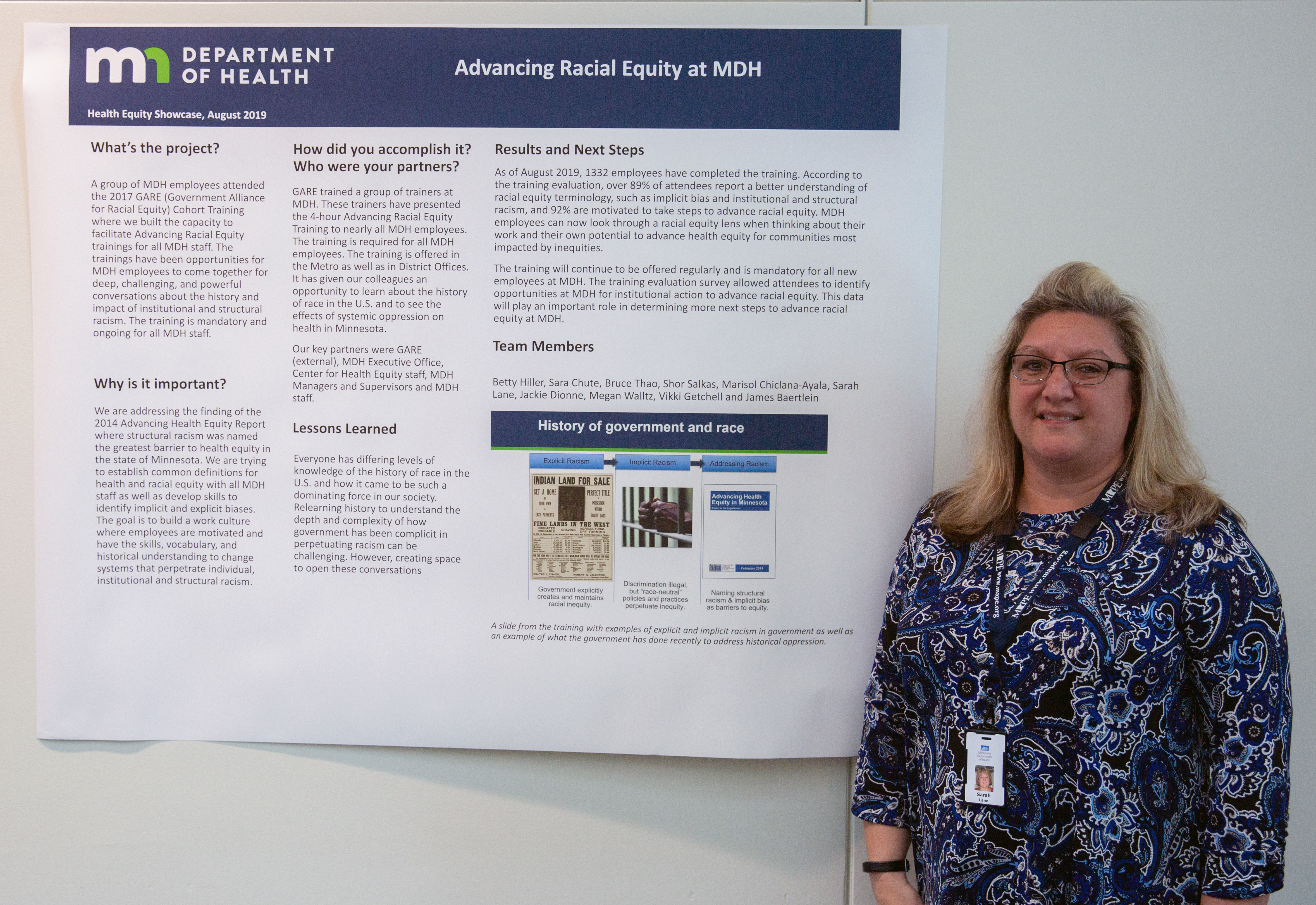 Photo of project lead with poster - advancing racial equity project