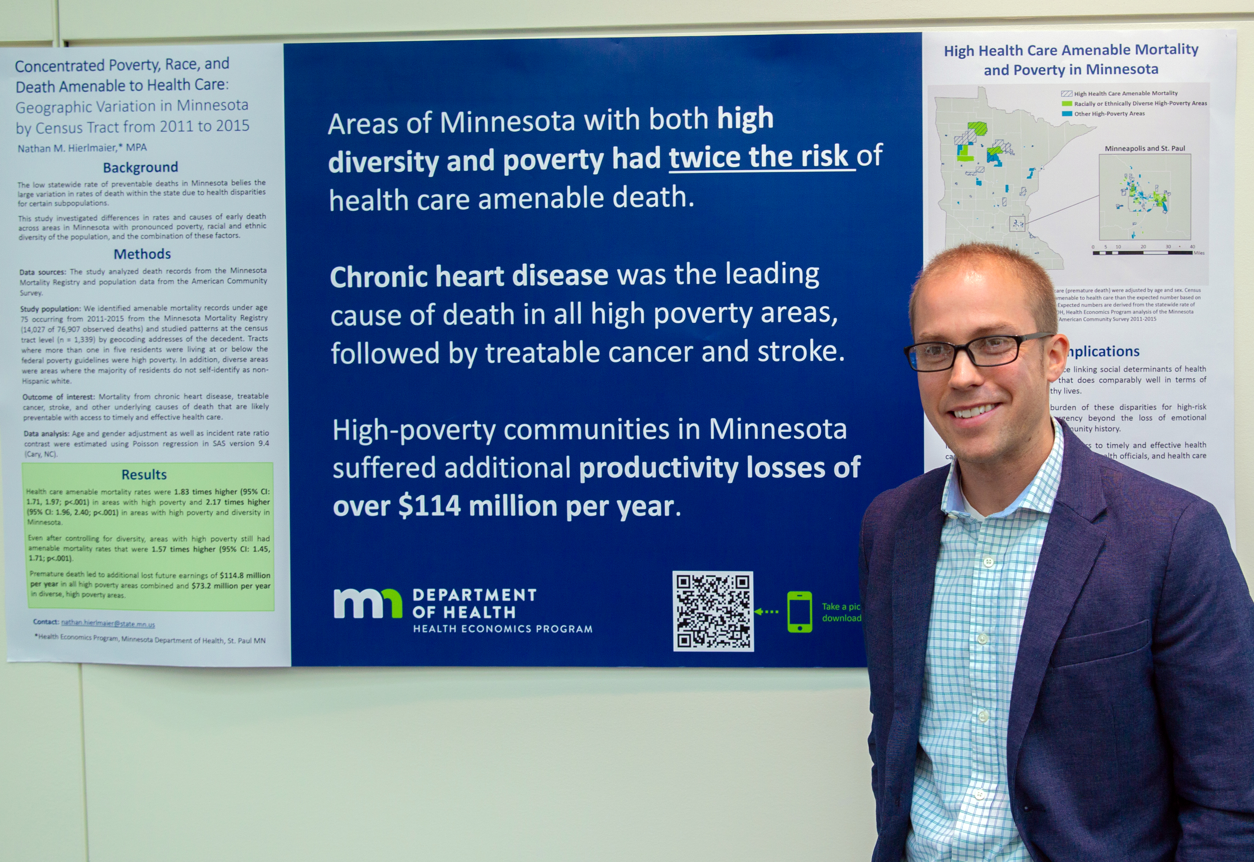 Photo of project lead with poster - study of poverty and disparities project