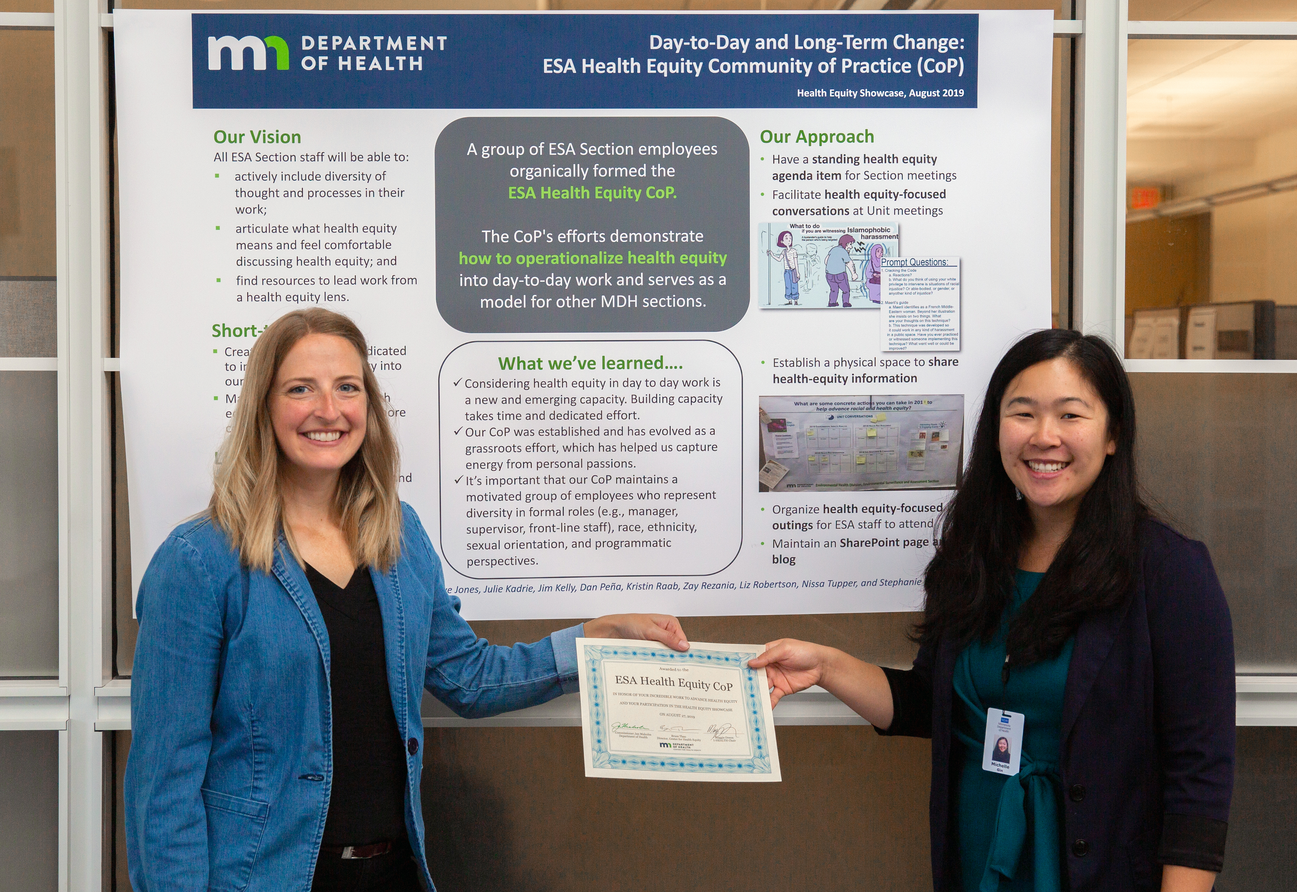 Photo of project leads with poster - community of practice project