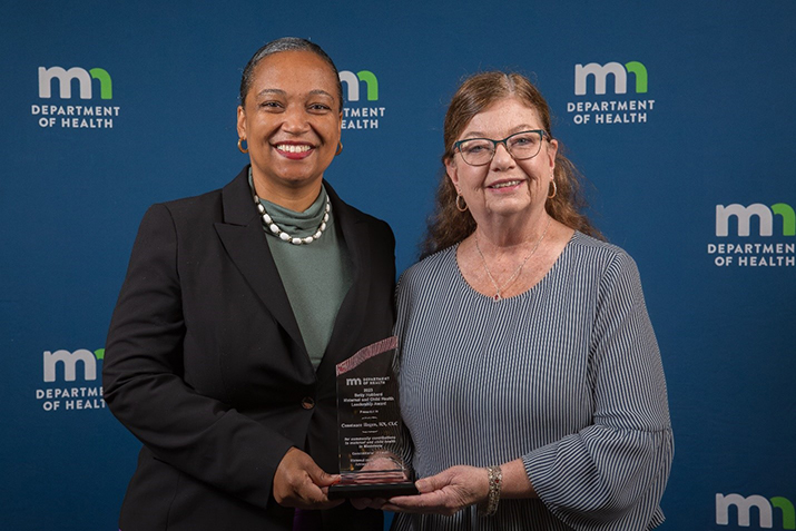 Connie Hagen receiving award from Commissioner Cunningham.