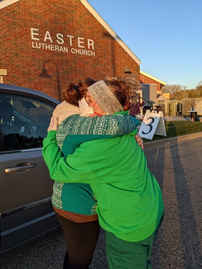 Dakota Child and Family Clinic care coordinator and medical assistant Bath-sheba Kemp hugs a friend in joy and relief, after delivering the COVID-19 vaccine to her child at the clinic's first child vaccine clinic.