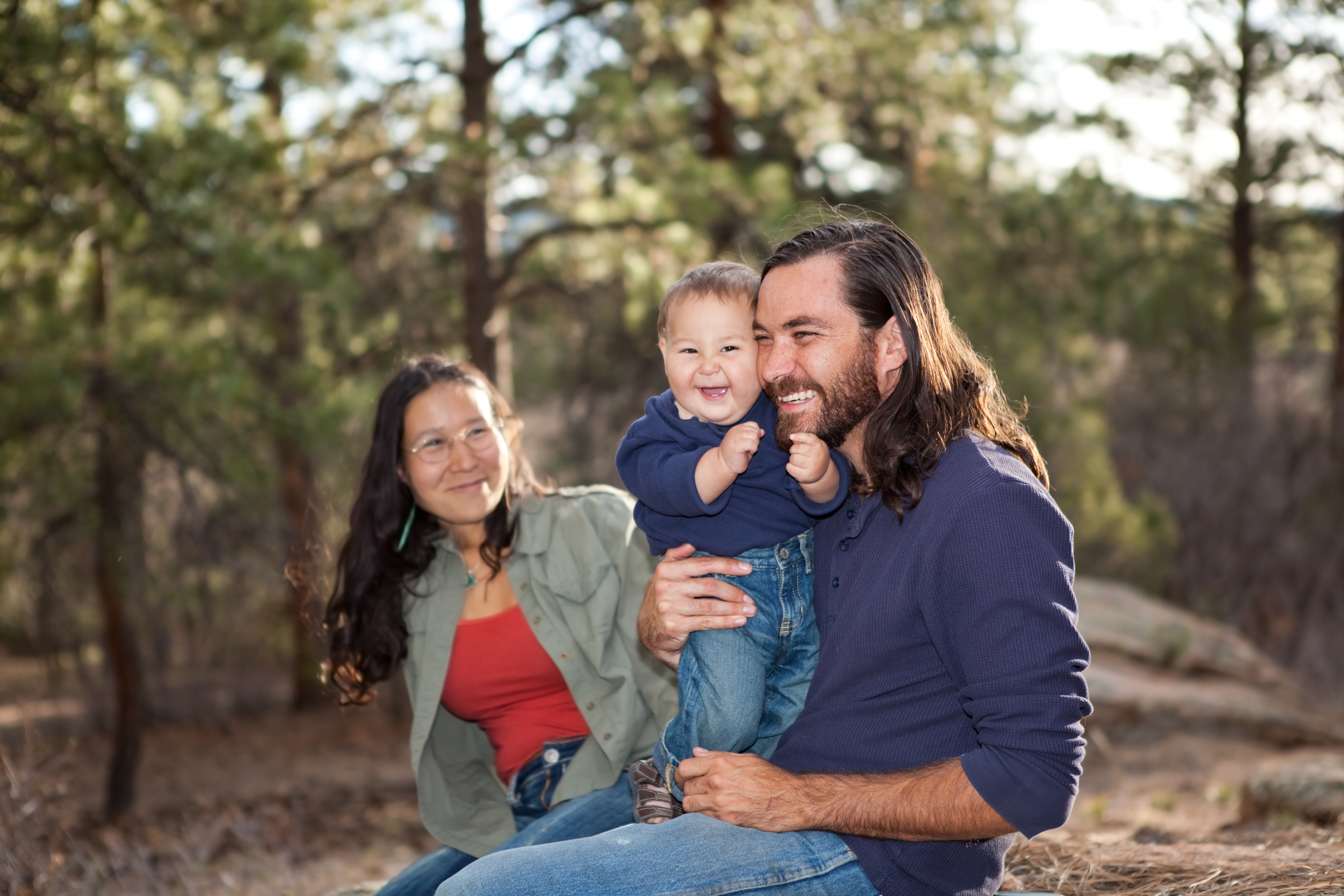 A Native American family laughing and smiling together