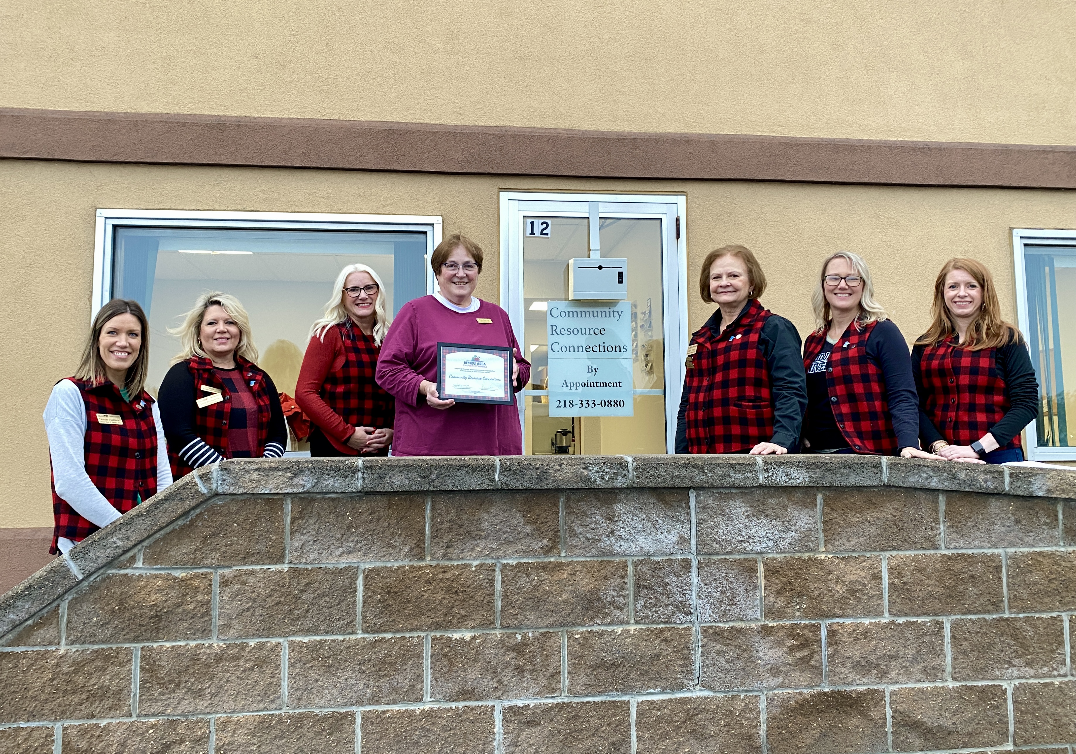 Bemidji Chamber Ambassadors congratulate Executive Director Ruth Sherman on the new location of Community Resource Connections. Photo courtesy of the Bemidji Chamber of Commerce.