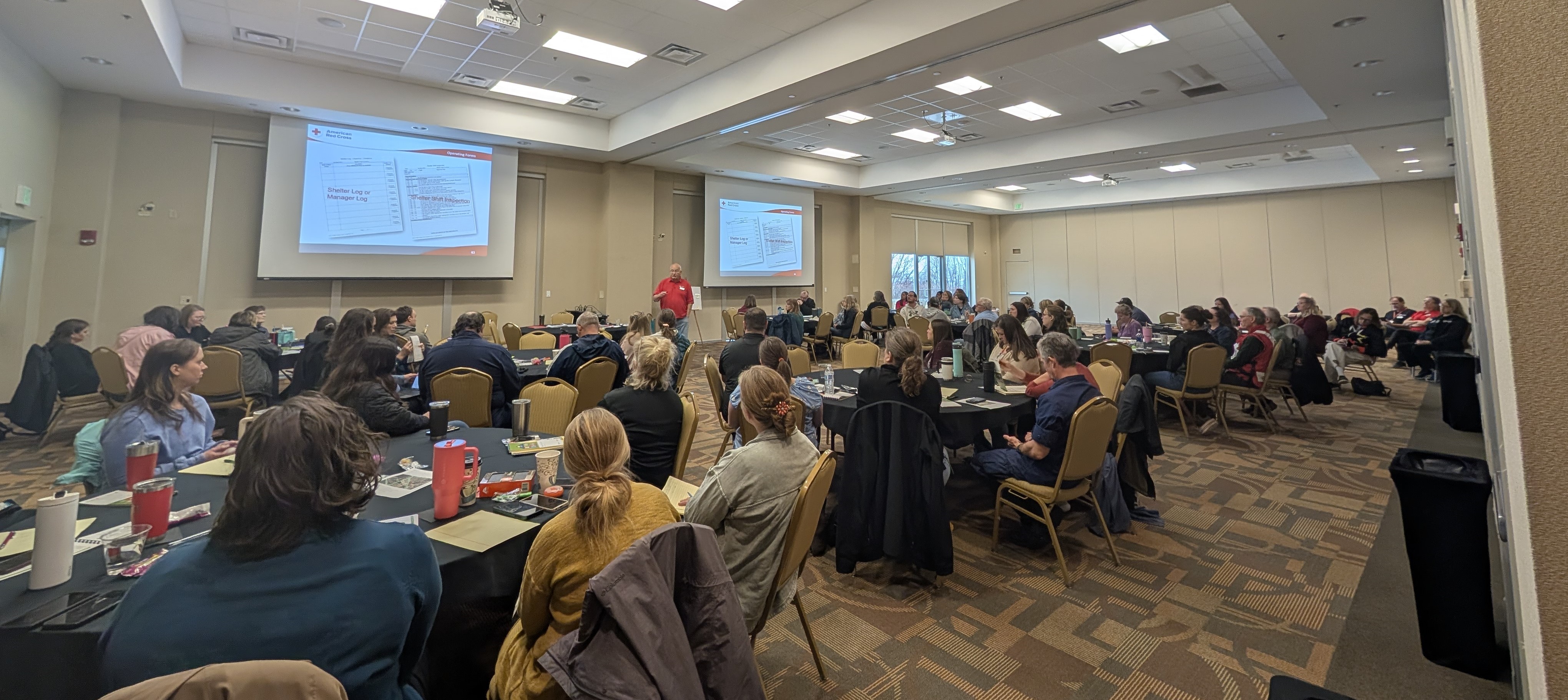 Staff from Bemidji-area cities, counties, and organizations convene in April 2025 for classroom training on running an emergency shelter, before breaking into small groups to learn hands-on shelter skills. 