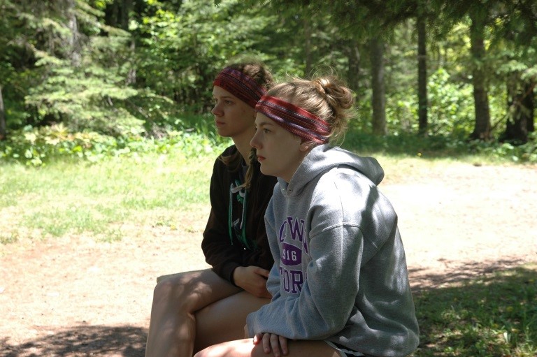 image: Youth leaders Erica VanDenheuvel (left) and Maci Fox (right) learn how goals are reached through teamwork—on the ropes course and in life.