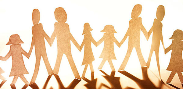 Paper cutout of family holding hands.
