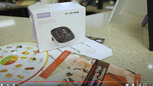 a blood pressure monitor box and some flyers on a table.