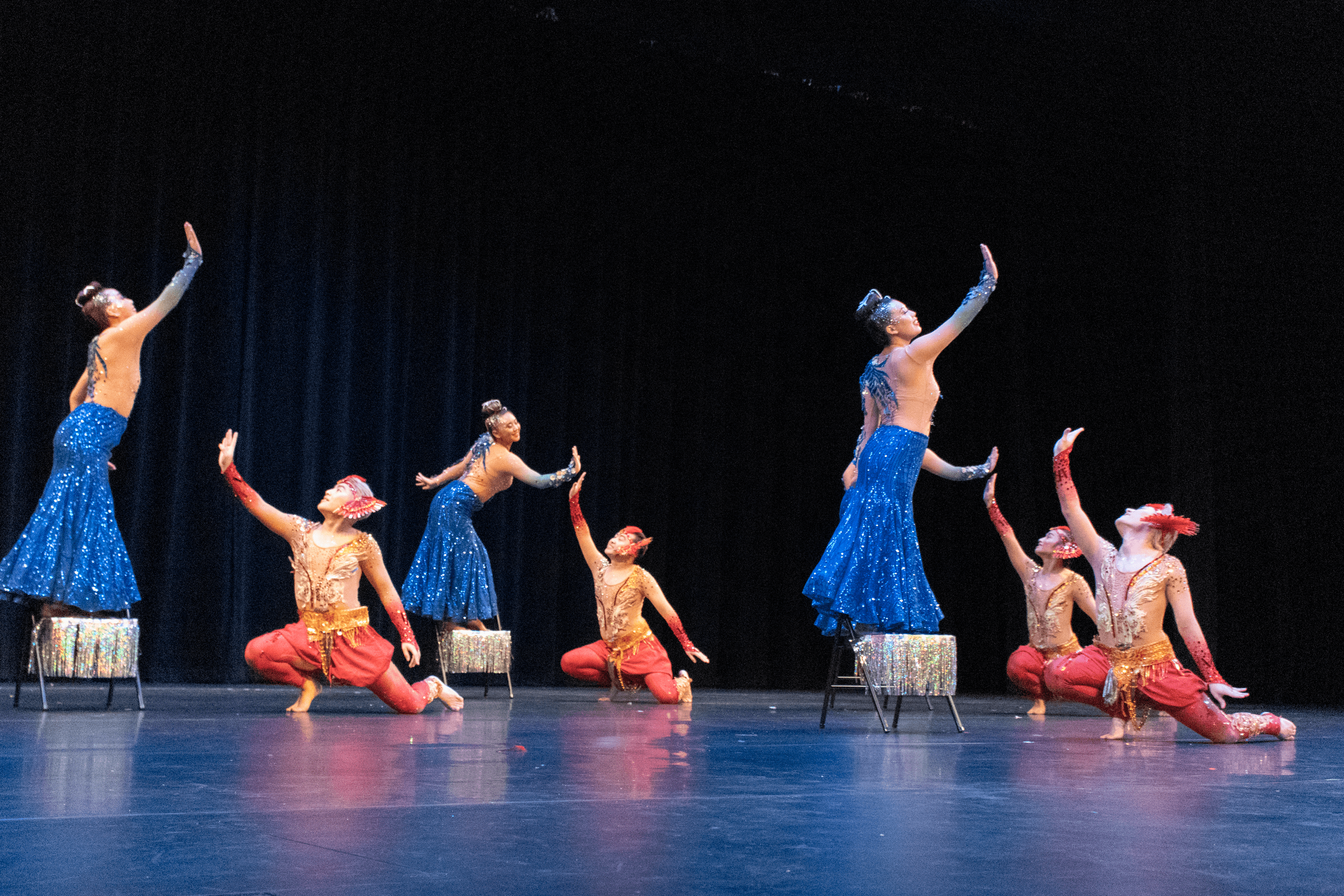 Performers on stage in dramatic poses