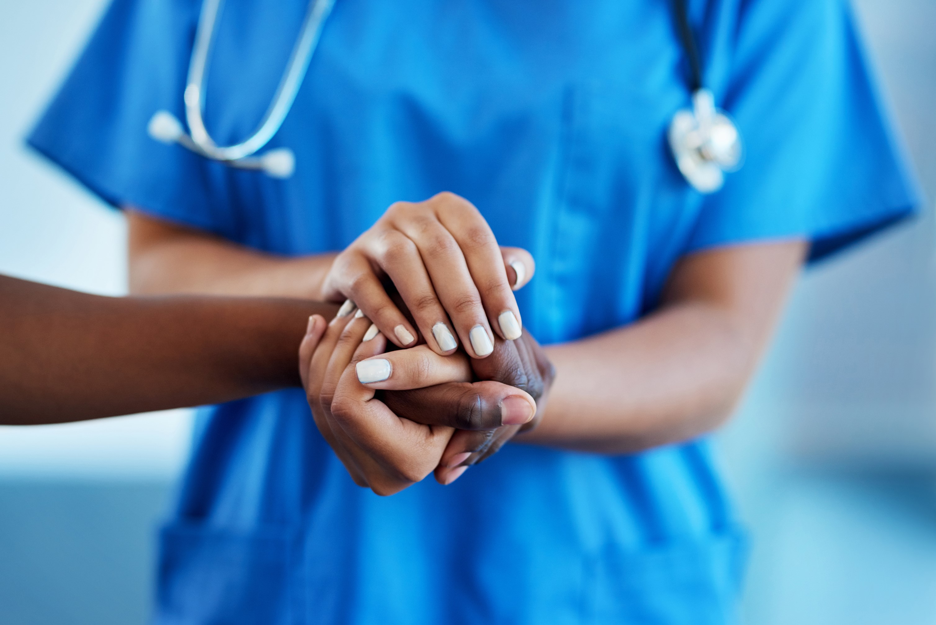 nurse and patient holding hands