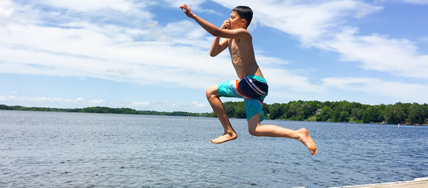 kid jumping into lake