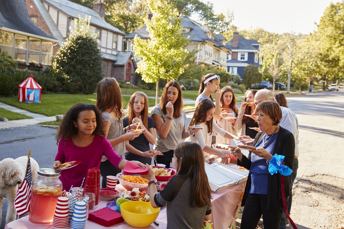 Group of women and girls enjoying food at a block party