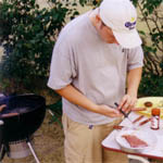 Image of man cooking on the grill.