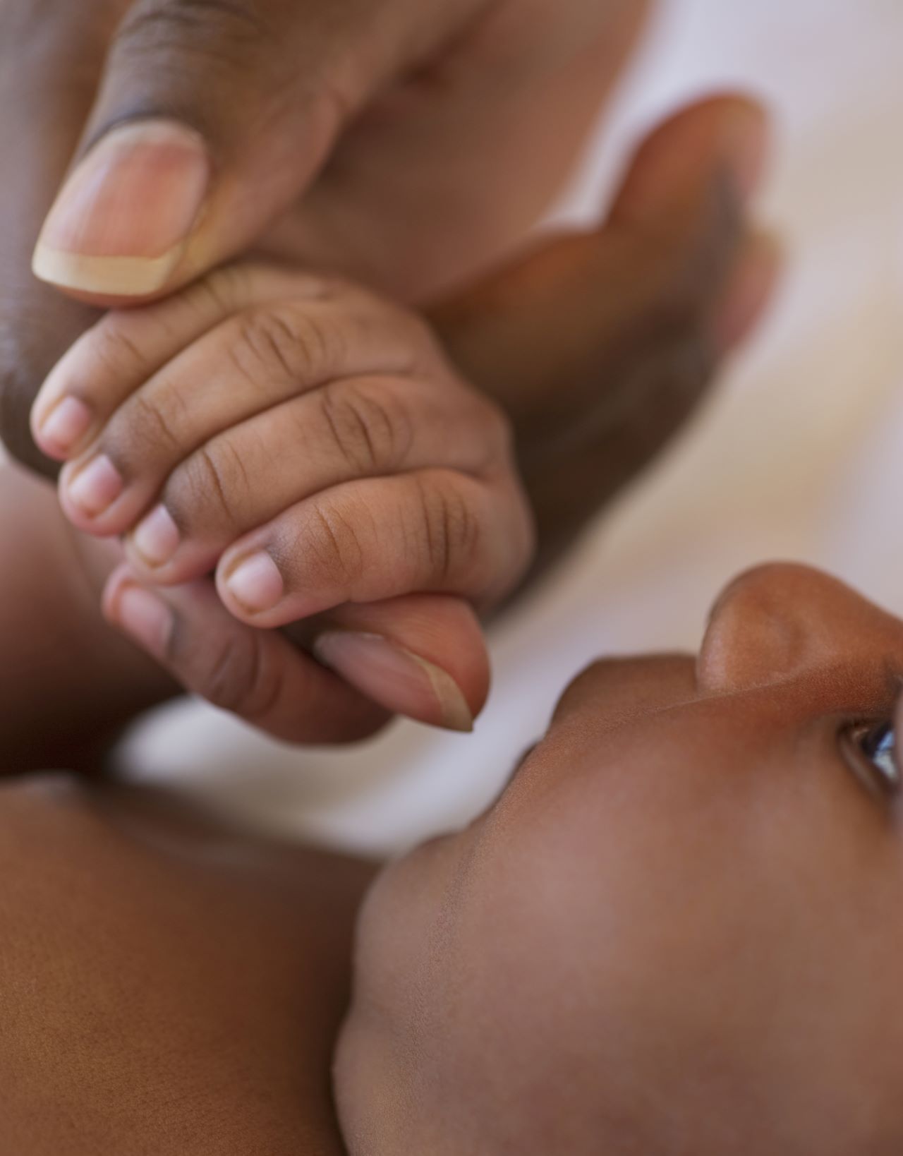 Baby holding onto finger