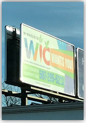 WIC billboard on roadside.