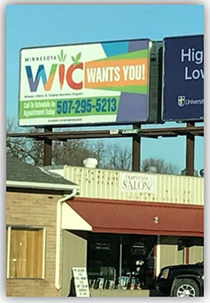 WIC billboard above buildings.