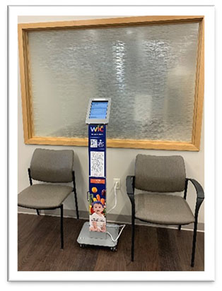 Standing kiosk with tablet for completing online WIC application and WIC pamphlets.