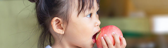 little girl eating apple