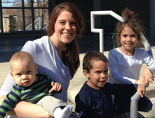 Mom and three children sitting on steps and smiling