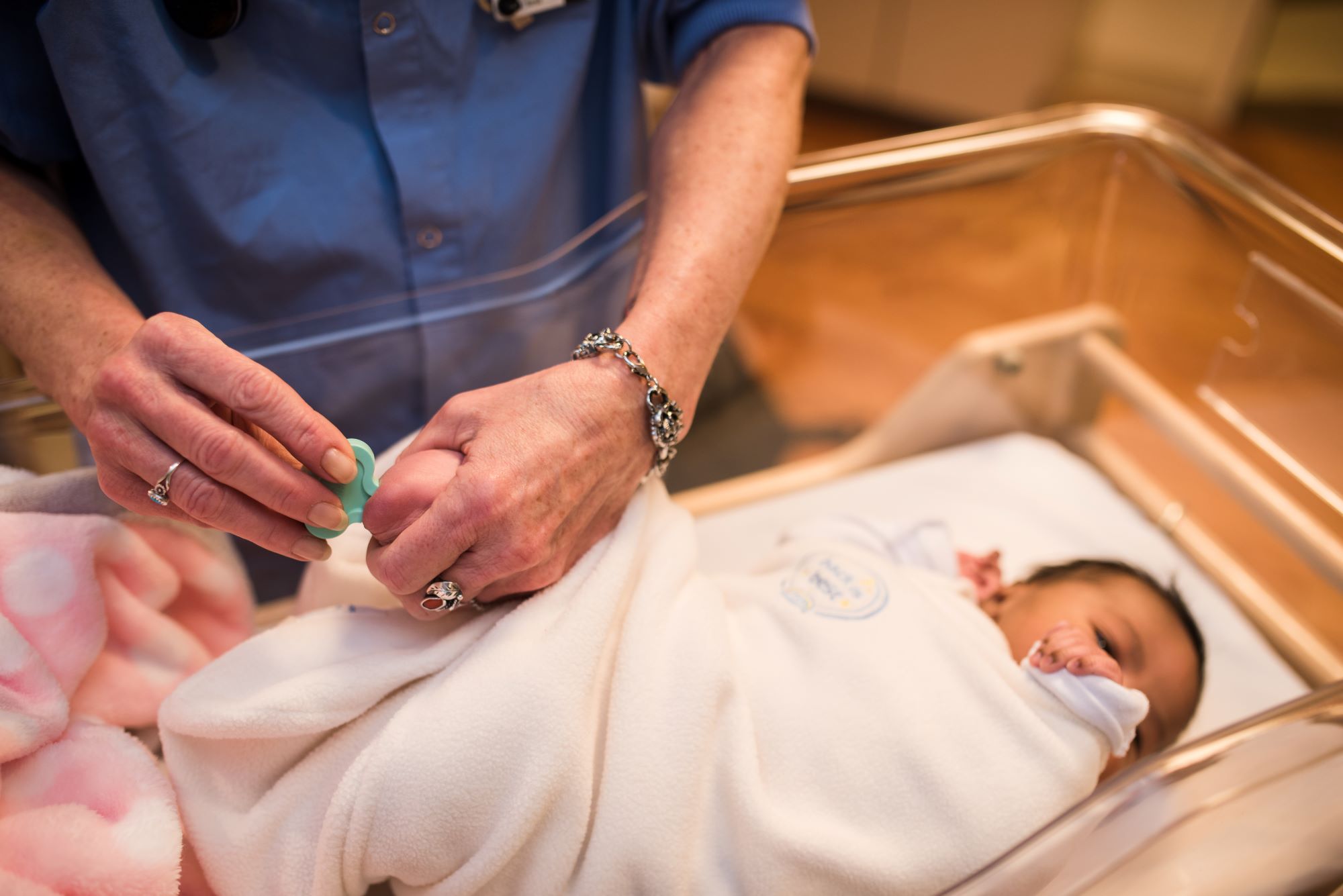 Baby undergoing blood spot screening